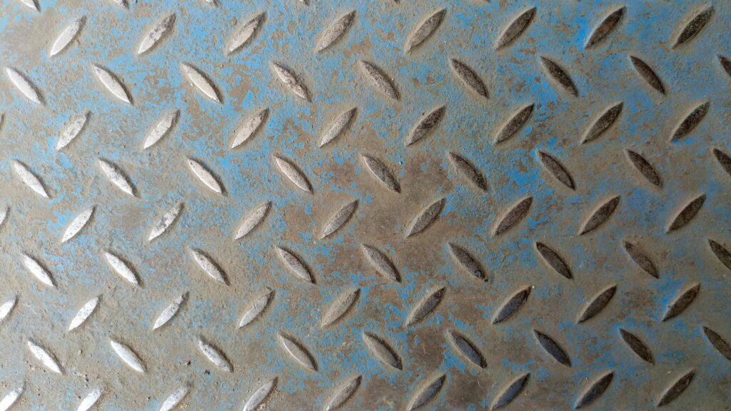 This photo shows a rusted and degraded metal floor that creates a contamination risk for sensitive next-generation AI systems