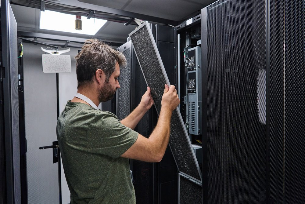 A tech at a data center replacing a filter