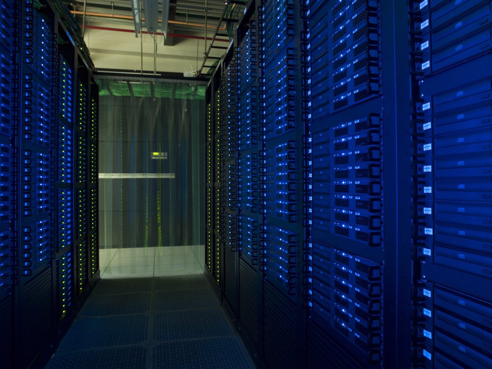 Enterprise data center with raised floor infrastructure supporting underfloor cable management and cooling airflow beneath server cabinets.