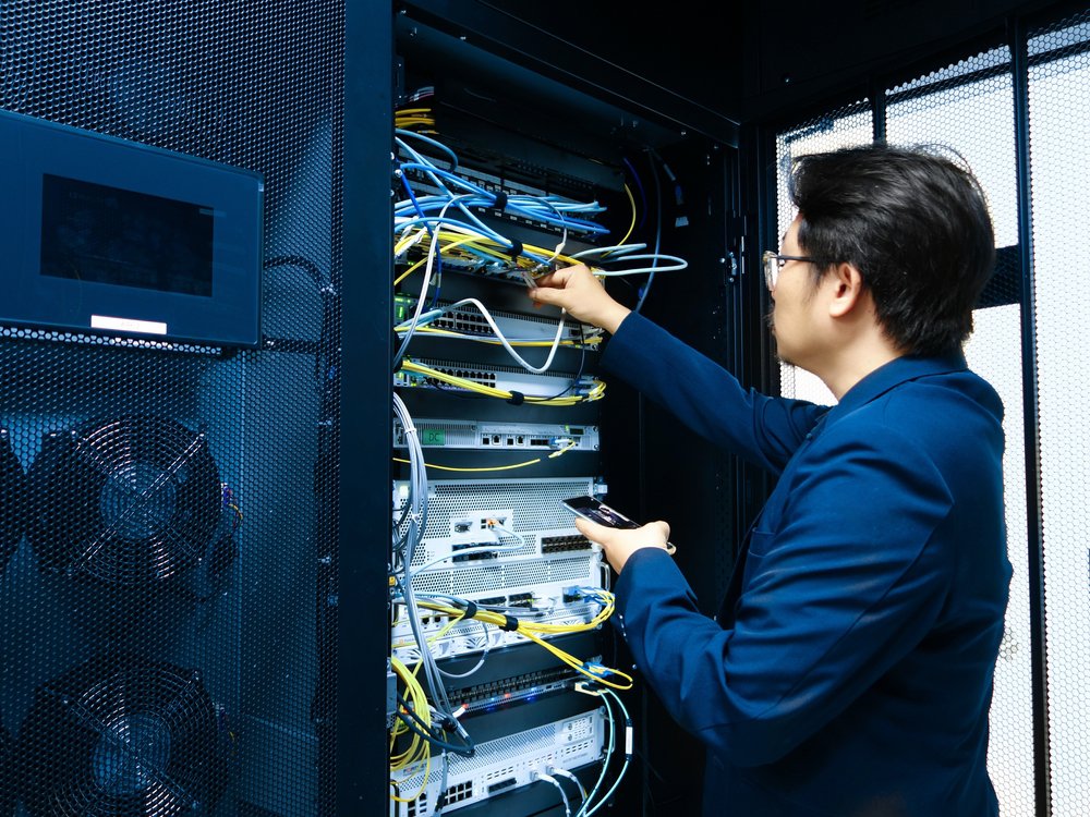 High-density data center aisle operating under cleanroom standards with particle monitoring sensors and strict contamination control protocols.