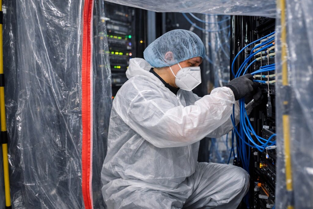data center cabling done by an engineer in a protective suit